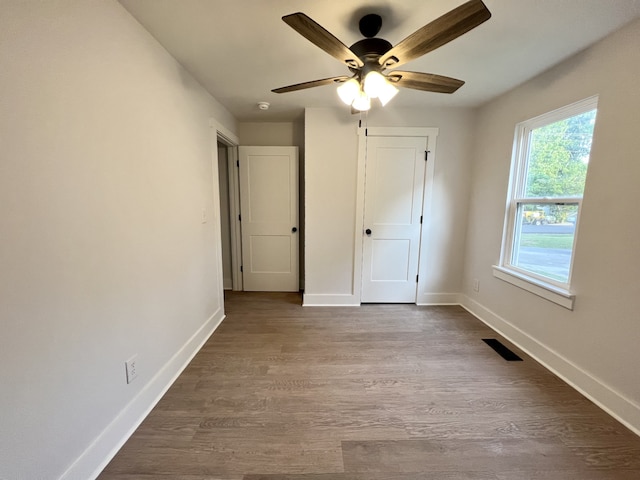 unfurnished bedroom featuring hardwood / wood-style flooring and ceiling fan