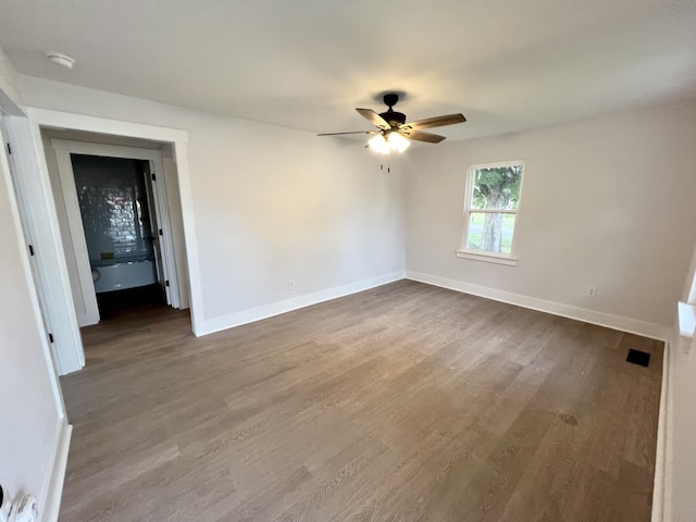 empty room with hardwood / wood-style flooring and ceiling fan