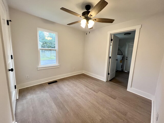 unfurnished bedroom with hardwood / wood-style floors and ceiling fan