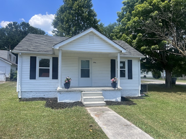 bungalow-style home featuring a porch and a front lawn