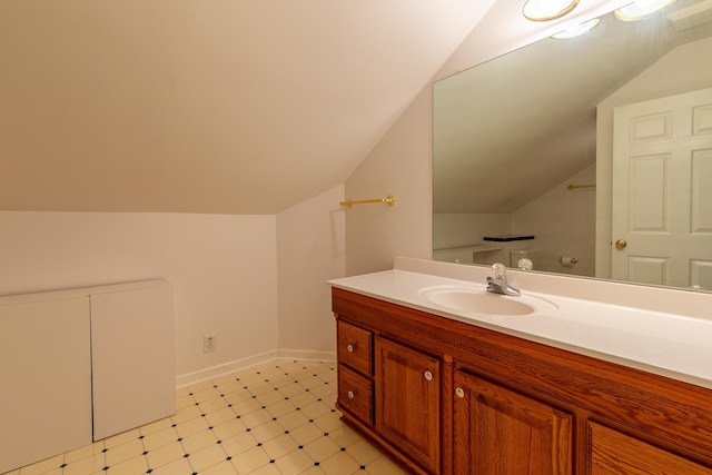 bathroom featuring lofted ceiling, tile patterned floors, and vanity