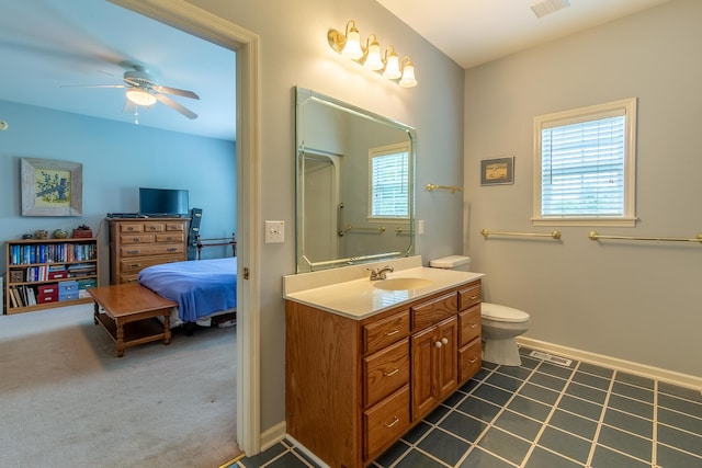 bathroom featuring vanity, tile patterned floors, ceiling fan, and toilet