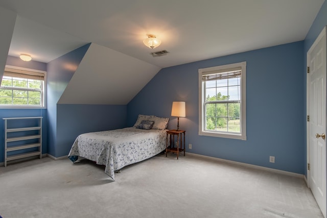 carpeted bedroom featuring vaulted ceiling