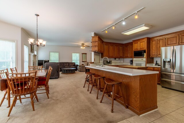 160 Sinking Creek Rd, Petersburg, TN 37144 - kitchen featuring stainless steel refrigerator with ice dispenser, built in microwave, oven, brown cabinetry, and a kitchen breakfast bar