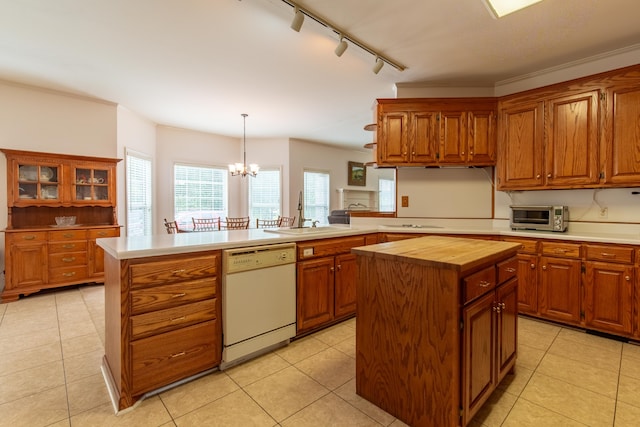 kitchen with a notable chandelier, light tile patterned flooring, dishwasher, and a center island