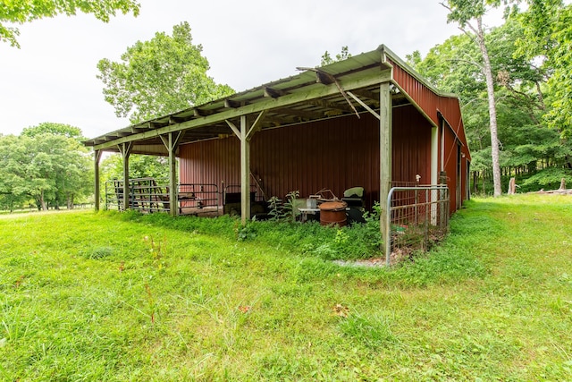 view of home's exterior featuring a lawn and an outbuilding