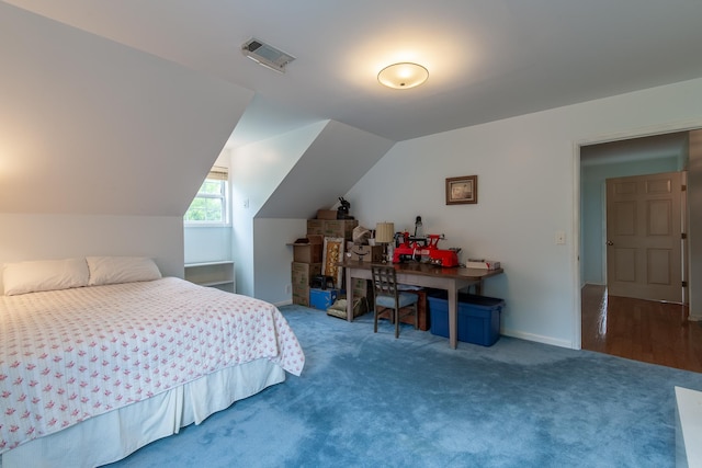 bedroom featuring lofted ceiling and hardwood / wood-style floors