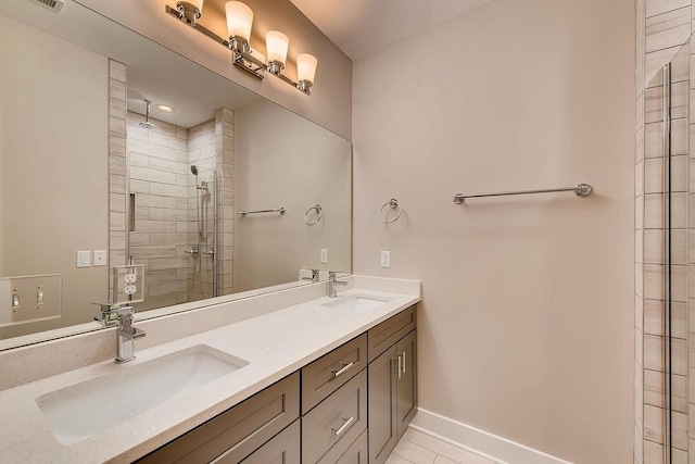 bathroom featuring double sink vanity, walk in shower, and tile patterned flooring