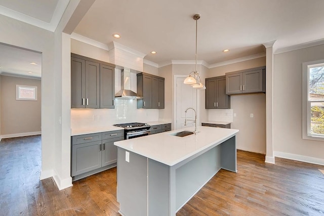 kitchen with light hardwood / wood-style floors, sink, backsplash, and wall chimney exhaust hood