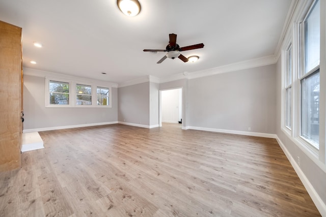 empty room featuring crown molding, ceiling fan, and light wood-type flooring