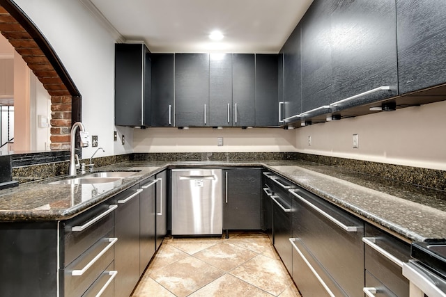 kitchen with sink, light tile patterned floors, ornamental molding, dishwasher, and dark stone counters