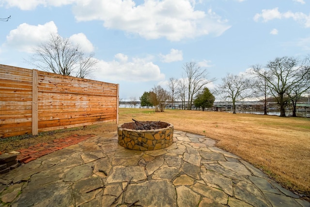 view of patio featuring a water view and an outdoor fire pit