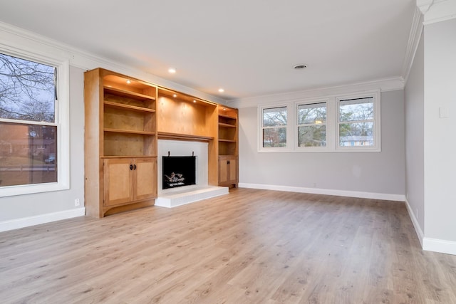 unfurnished living room featuring crown molding and light wood-type flooring