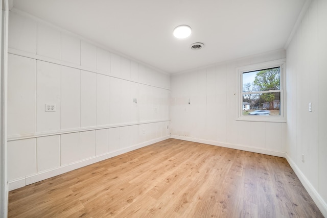 unfurnished room with crown molding and light hardwood / wood-style flooring