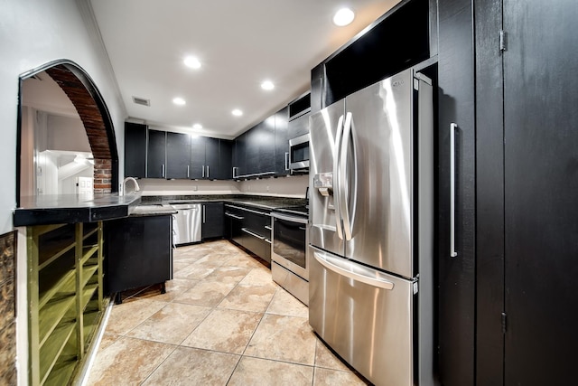 kitchen featuring stainless steel appliances, sink, and light tile patterned floors