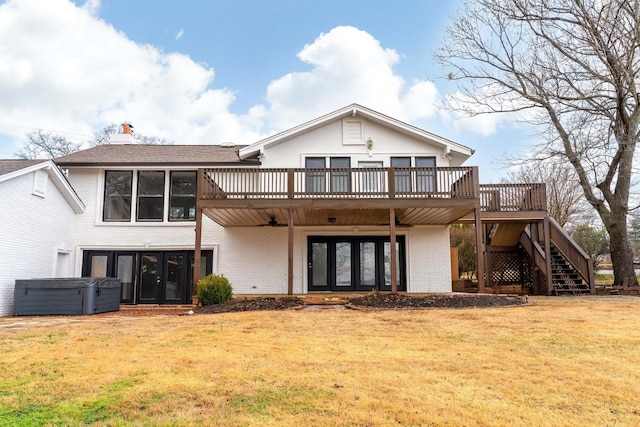 back of house with a wooden deck, a yard, and french doors