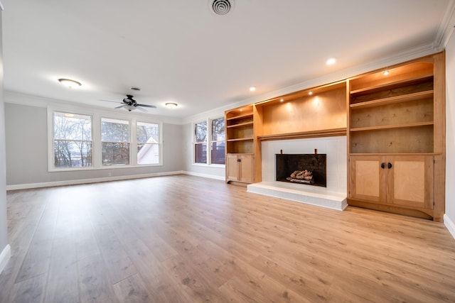 unfurnished living room with crown molding, ceiling fan, light hardwood / wood-style flooring, and built in features