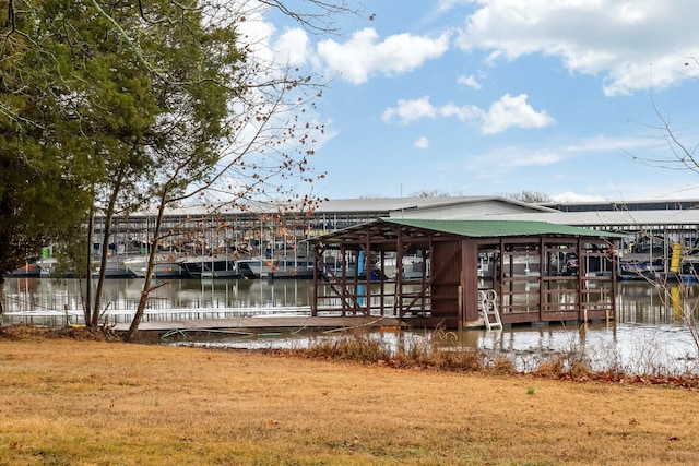 view of dock featuring a water view and a lawn