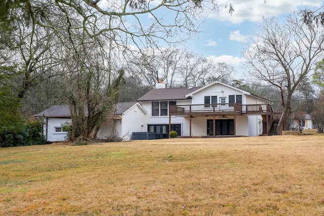 back of property featuring a yard, central AC, and a deck