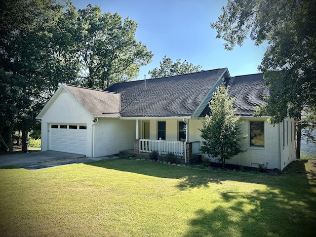 view of front of property featuring a garage, a porch, and a front lawn