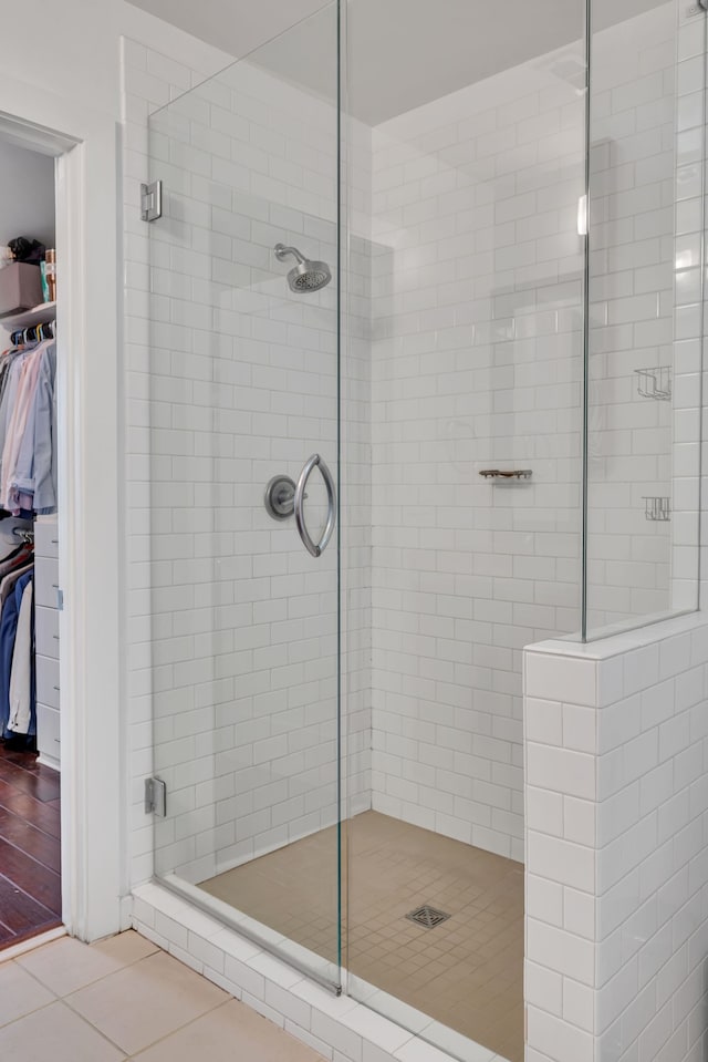 bathroom with walk in shower and tile patterned flooring