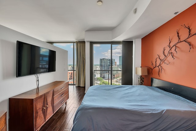 bedroom featuring floor to ceiling windows, access to outside, and dark wood-type flooring