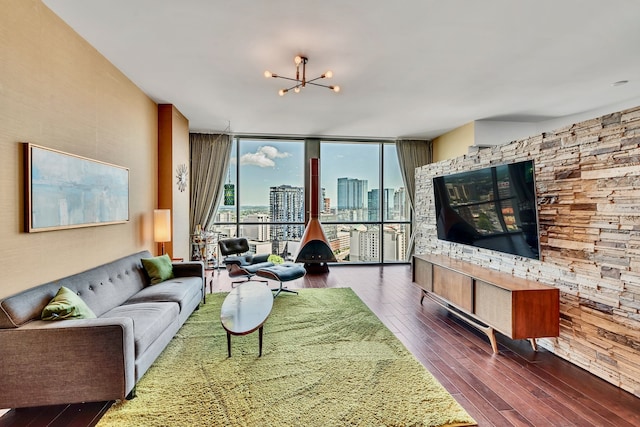 living room featuring an inviting chandelier, dark hardwood / wood-style floors, and floor to ceiling windows