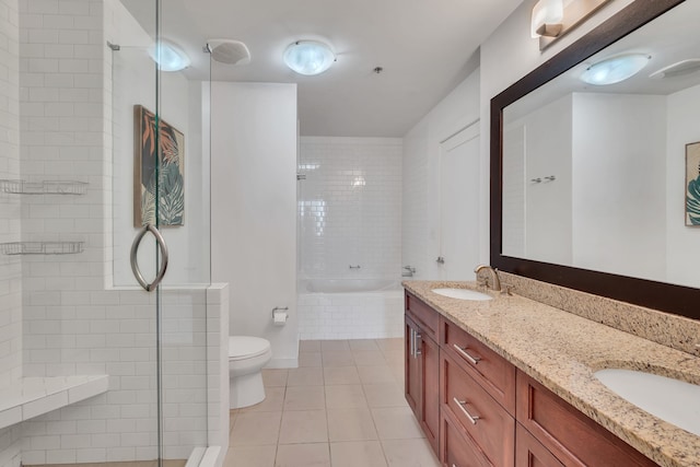 bathroom with dual vanity, tile patterned floors, and toilet