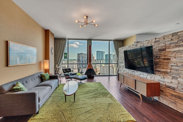 living room featuring a chandelier, dark hardwood / wood-style floors, and floor to ceiling windows