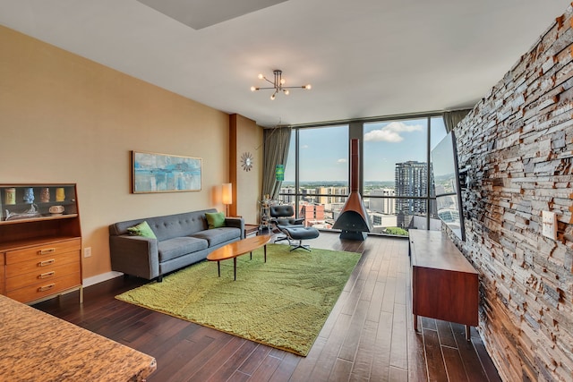 living room featuring a notable chandelier, expansive windows, and dark hardwood / wood-style floors