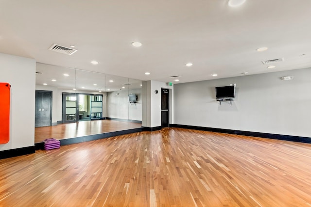 exercise area featuring light hardwood / wood-style floors