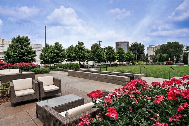 view of home's community featuring a patio and a lawn