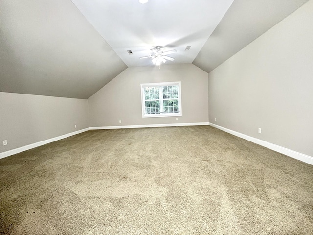 bonus room featuring visible vents, baseboards, ceiling fan, carpet, and vaulted ceiling
