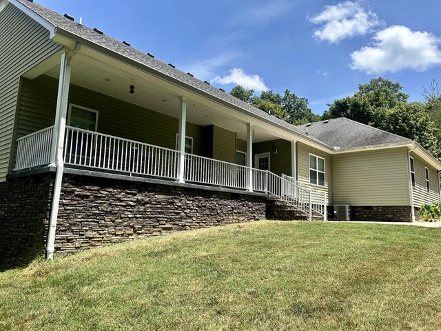 back of house with a yard and central AC unit