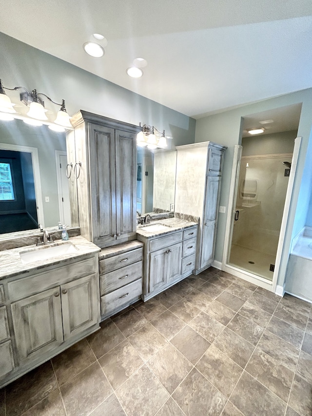 bathroom featuring tile patterned flooring, a shower with shower door, and double sink vanity