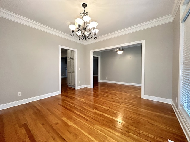 interior space with a chandelier, hardwood / wood-style flooring, and crown molding