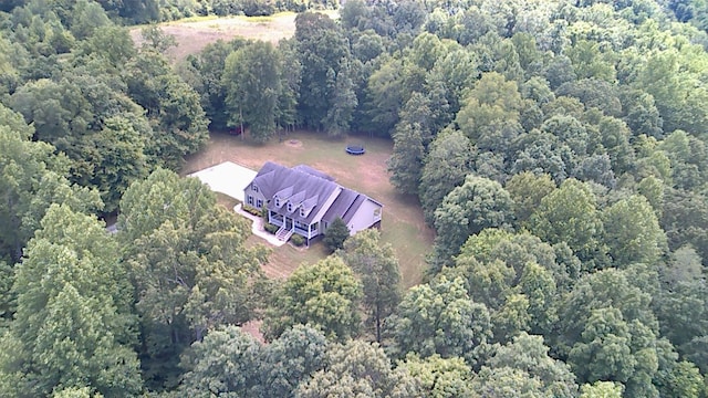 drone / aerial view featuring a wooded view