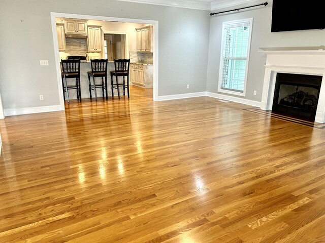 living room featuring ornamental molding and light hardwood / wood-style floors