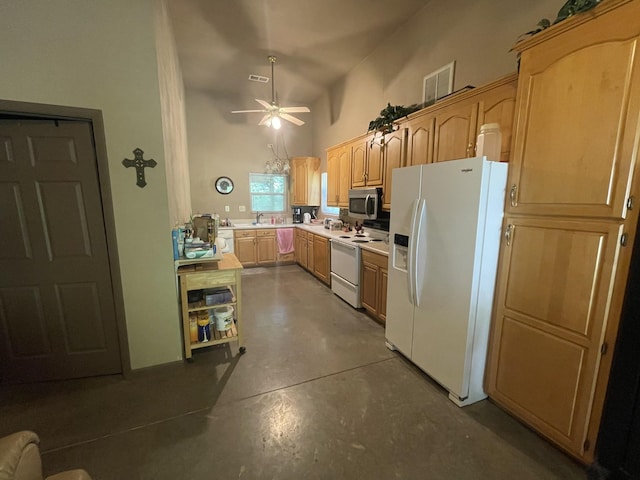 kitchen featuring white appliances, sink, ceiling fan, a towering ceiling, and light brown cabinetry