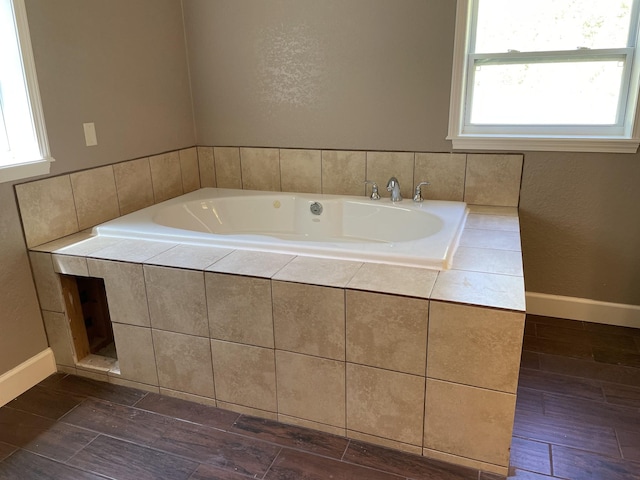 bathroom with tiled bath