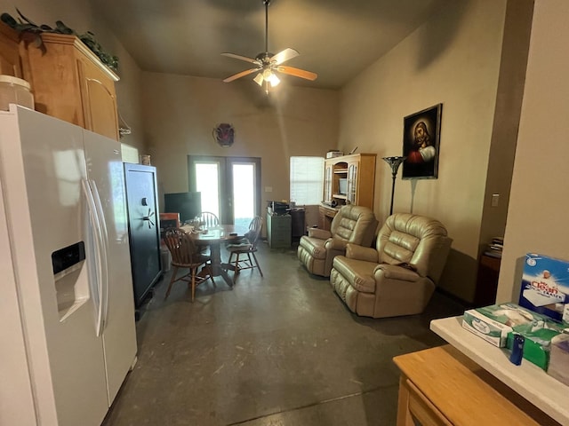 living room featuring a high ceiling and ceiling fan