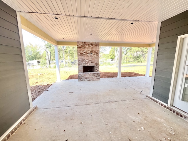 view of patio featuring an outdoor brick fireplace