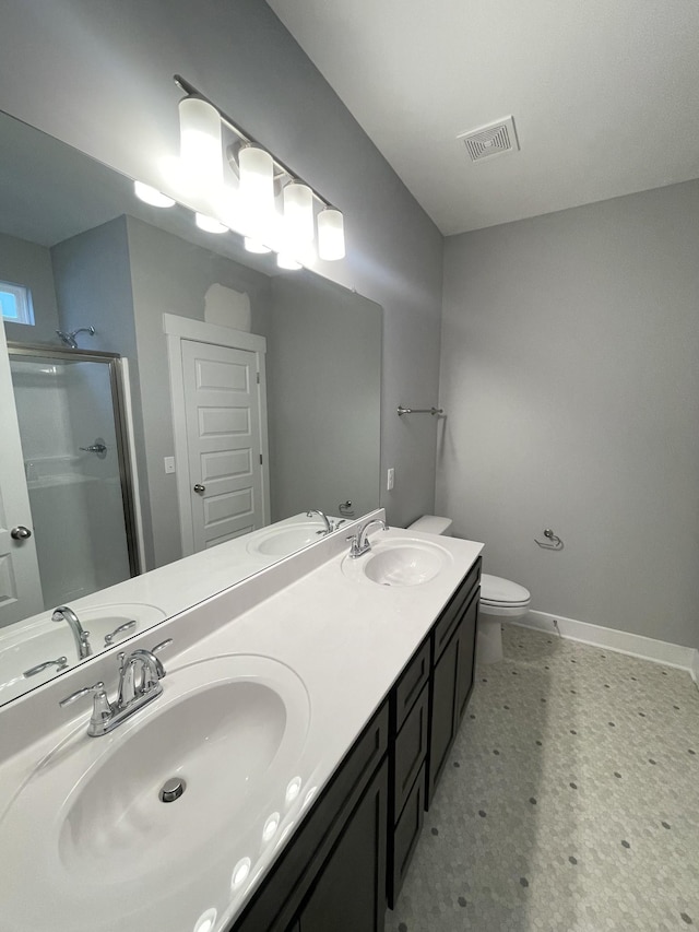 bathroom featuring an enclosed shower, vanity, and toilet