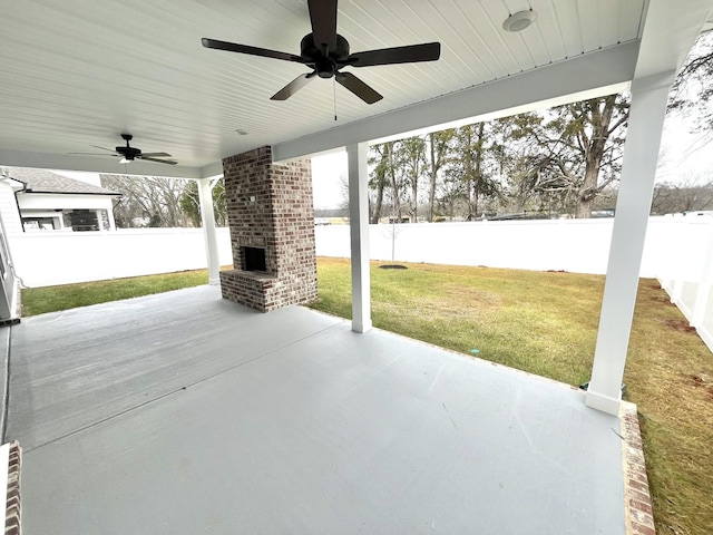 view of patio featuring an outdoor brick fireplace, ceiling fan, and a water view