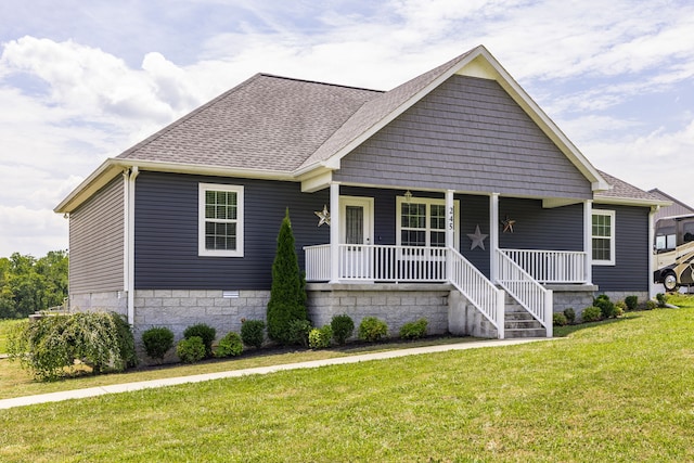 view of front of property with a porch and a front lawn