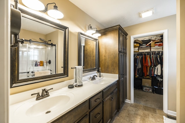 bathroom featuring tile patterned floors and dual bowl vanity