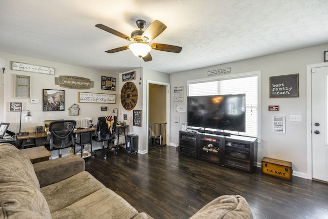 living room with dark hardwood / wood-style floors, a textured ceiling, and ceiling fan