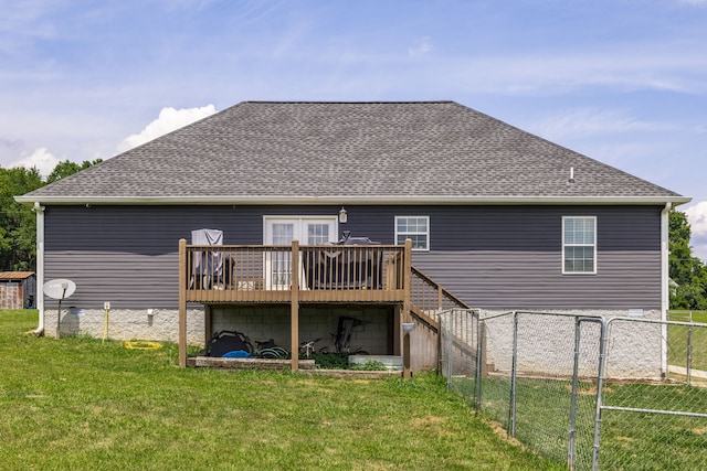 rear view of property with a yard and a deck