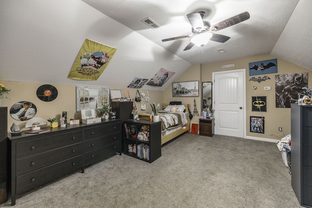 bedroom with light carpet, ceiling fan, vaulted ceiling, and a textured ceiling