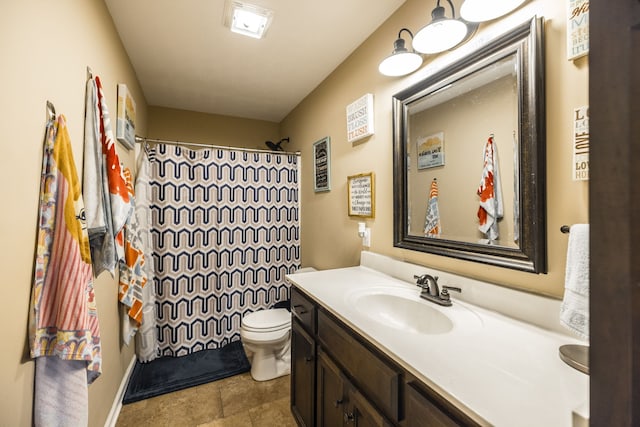 bathroom featuring vanity, tile patterned flooring, and toilet